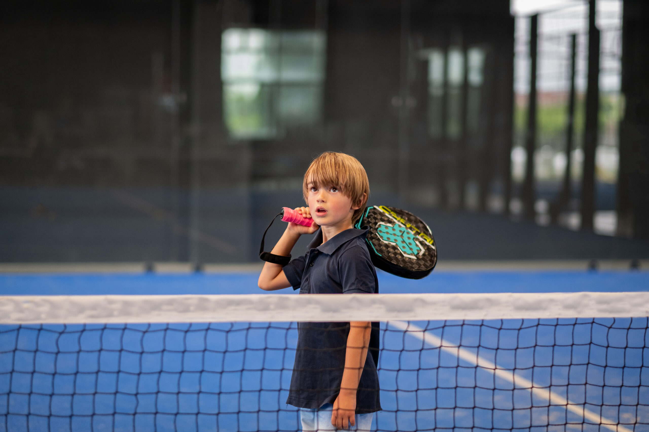 Monitor teaching padel class to child, his student - Trainer tea